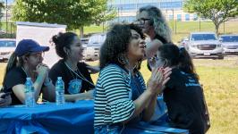 Brazilian women listening in Portuguese. Our wonderful Portuguese interpreter Juliana is standing in back